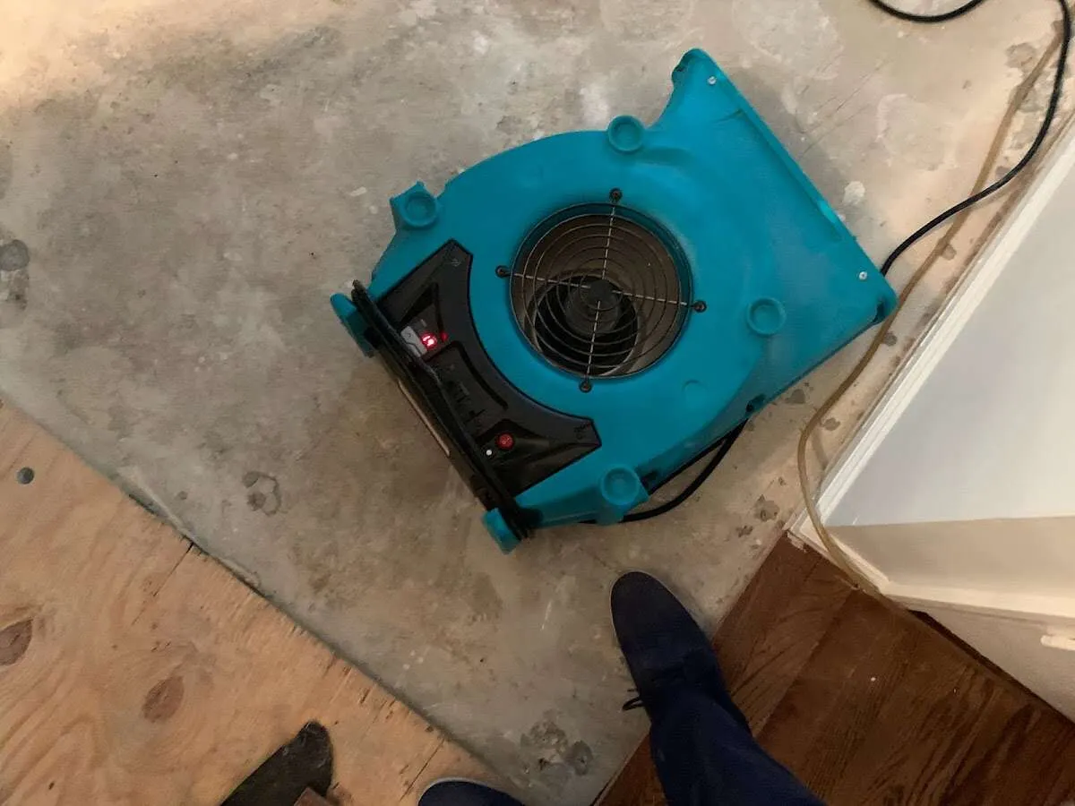 Air mover drying subfloor during Commercial Water Damage Restoration in Round Lake Beach